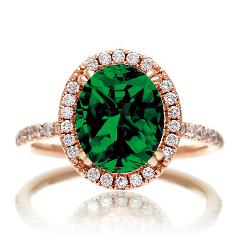 1.5 Carat Oval Classic Emerald and diamond halo ring on  